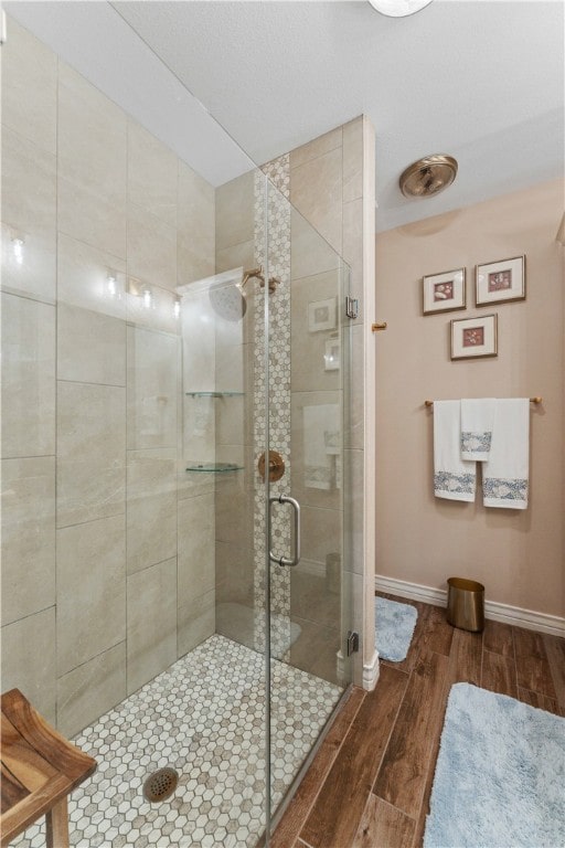 bathroom featuring walk in shower and hardwood / wood-style flooring