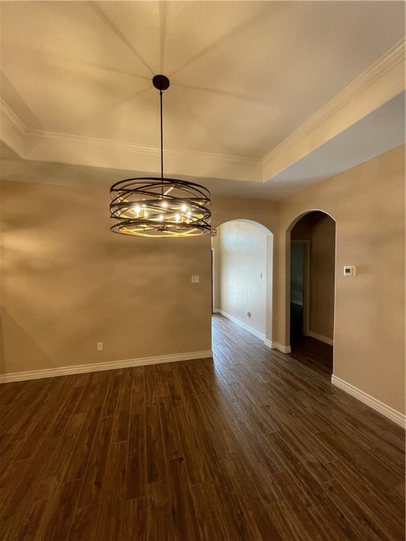 unfurnished dining area featuring dark hardwood / wood-style flooring, a chandelier, and crown molding