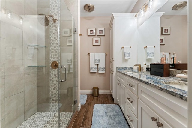 5422 Neela Ln, Corpus Christi, TX 78413 - full bathroom featuring a shower stall, wood finished floors, double vanity, and baseboards