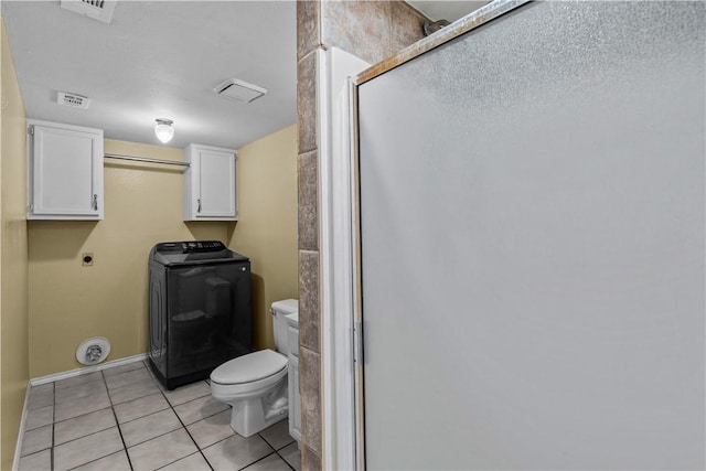 full bath with tile patterned floors, toilet, visible vents, a shower stall, and washer / clothes dryer
