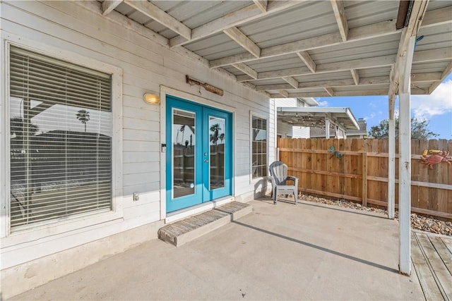 view of patio / terrace featuring fence and french doors