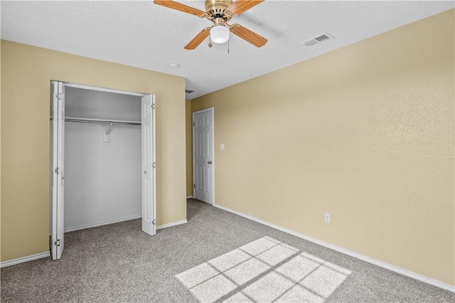 unfurnished bedroom with a textured ceiling, baseboards, visible vents, a closet, and carpet floors