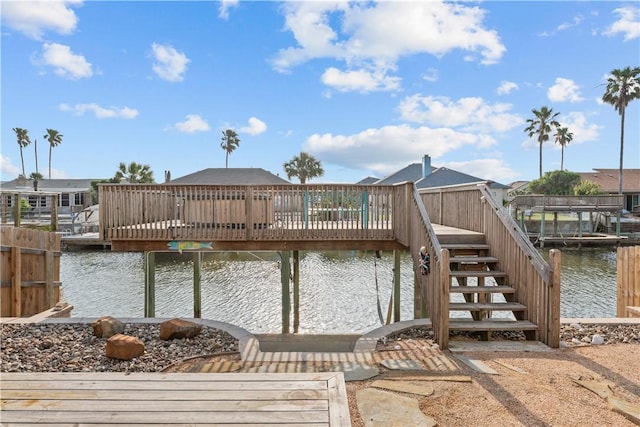 dock area with a deck with water view and stairway