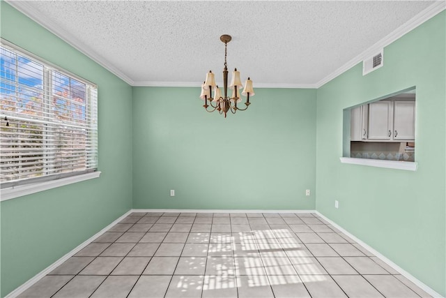 empty room with visible vents, a textured ceiling, a chandelier, and ornamental molding