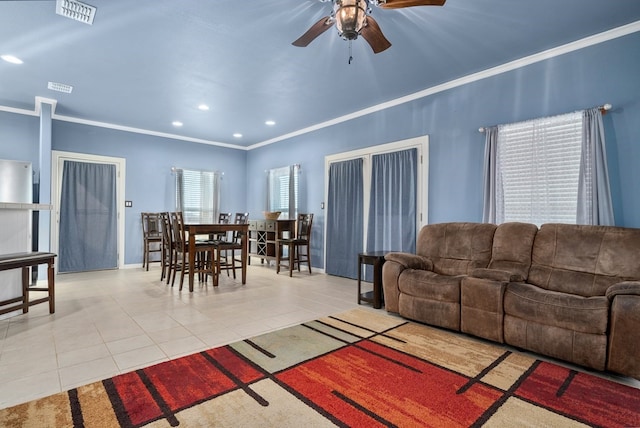 tiled living room featuring ceiling fan and crown molding