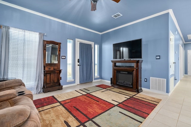 living room with crown molding, tile patterned flooring, ceiling fan, and a healthy amount of sunlight