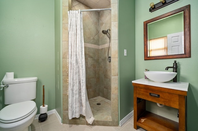 bathroom with a shower with shower curtain, vanity, toilet, and tile patterned floors