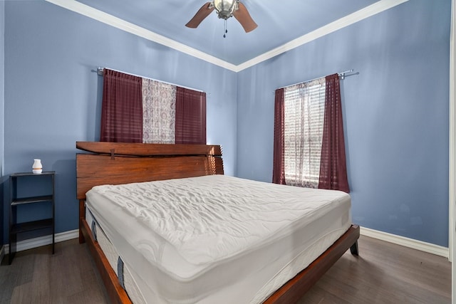 bedroom featuring ornamental molding, ceiling fan, and dark wood-type flooring