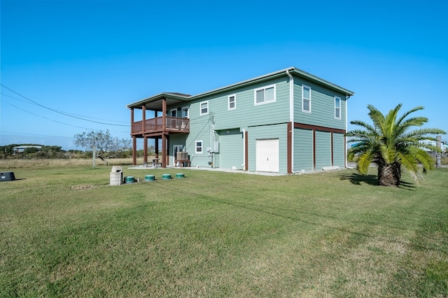 back of property featuring a garage, a yard, and a deck