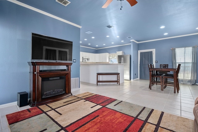 living room featuring ceiling fan, light tile patterned flooring, and crown molding