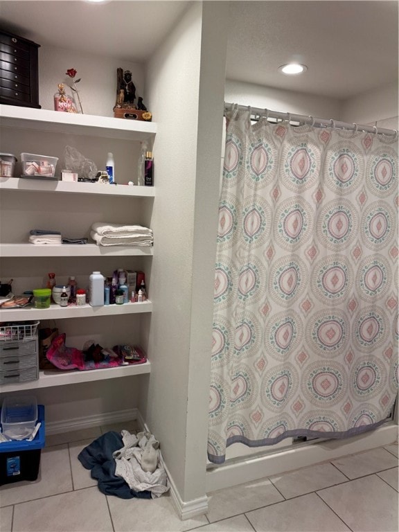 interior space featuring walk in shower and tile patterned flooring