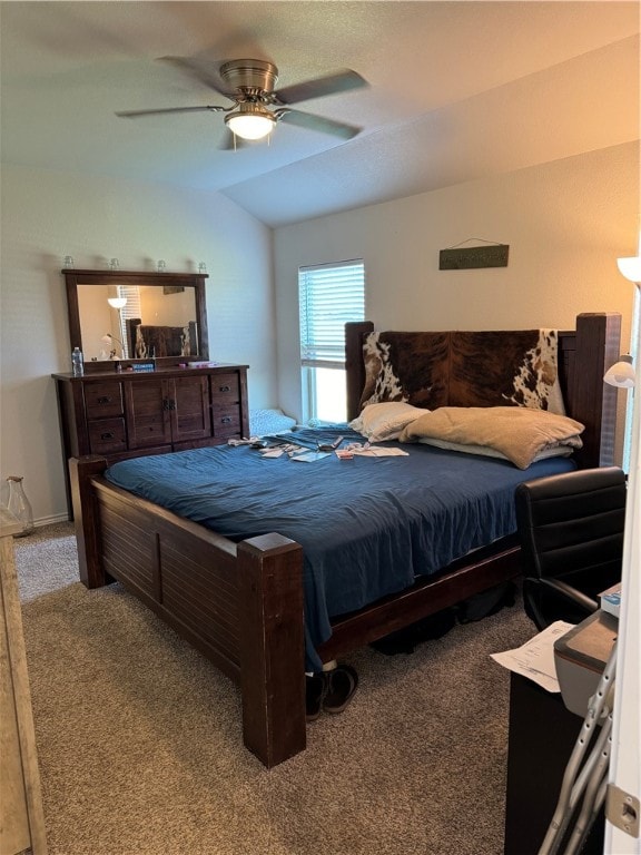 carpeted bedroom featuring ceiling fan and vaulted ceiling