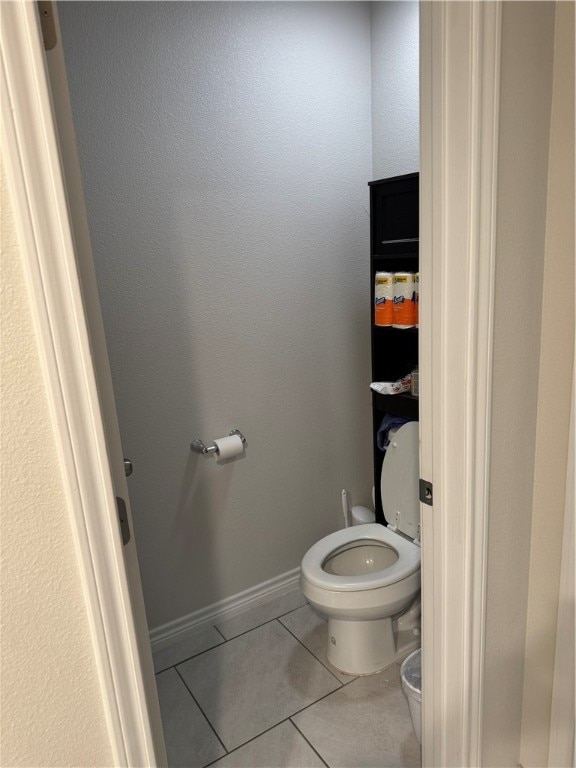 bathroom with tile patterned flooring and toilet