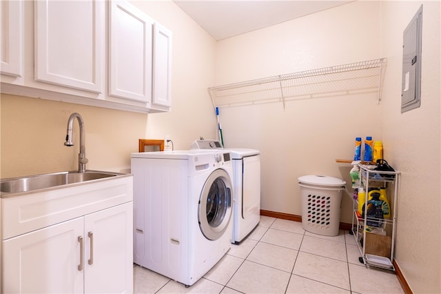 washroom with cabinets, light tile patterned flooring, separate washer and dryer, sink, and electric panel