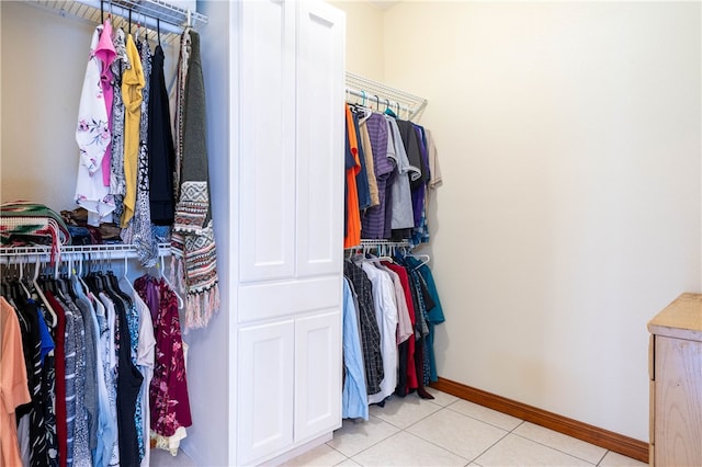 walk in closet with light tile patterned floors