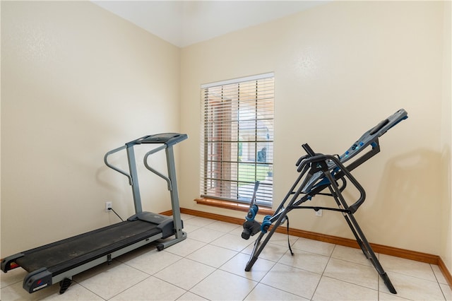 exercise area featuring light tile patterned flooring