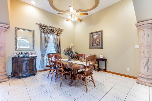 dining space featuring decorative columns, ceiling fan, and light tile patterned flooring