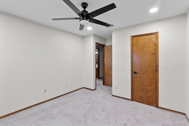 unfurnished bedroom with recessed lighting, light colored carpet, ornamental molding, a ceiling fan, and baseboards