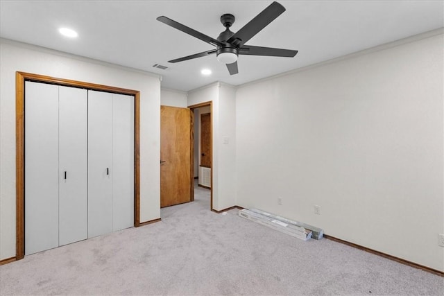 unfurnished bedroom featuring carpet, visible vents, a closet, and recessed lighting