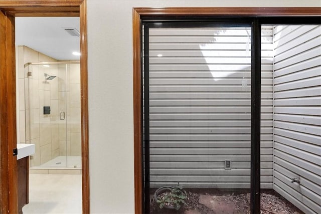 full bath featuring a shower stall and visible vents