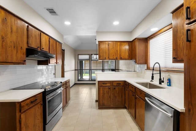 kitchen with under cabinet range hood, a sink, visible vents, appliances with stainless steel finishes, and brown cabinets