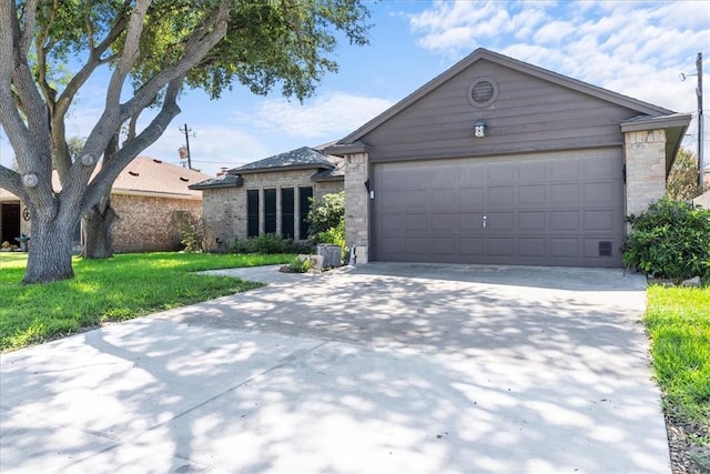 view of front of house with a garage, a front lawn, concrete driveway, and brick siding