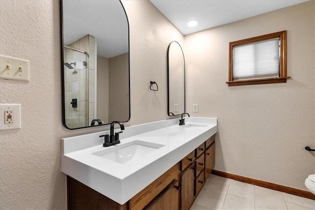 full bath with double vanity, baseboards, a sink, and tile patterned floors