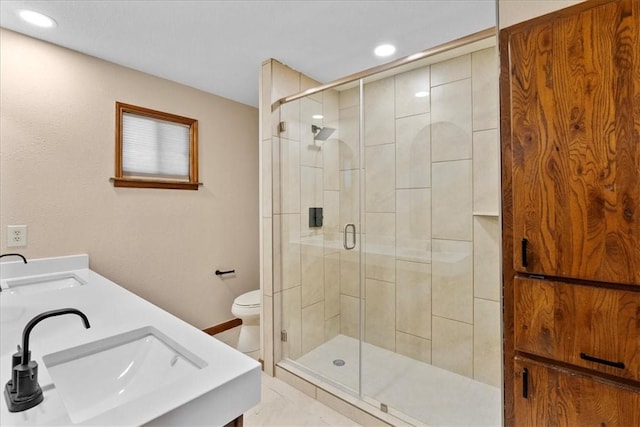 full bathroom featuring a sink, toilet, and a shower stall