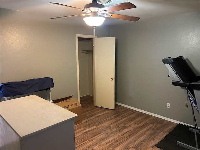 bedroom with ceiling fan, baseboards, and wood finished floors