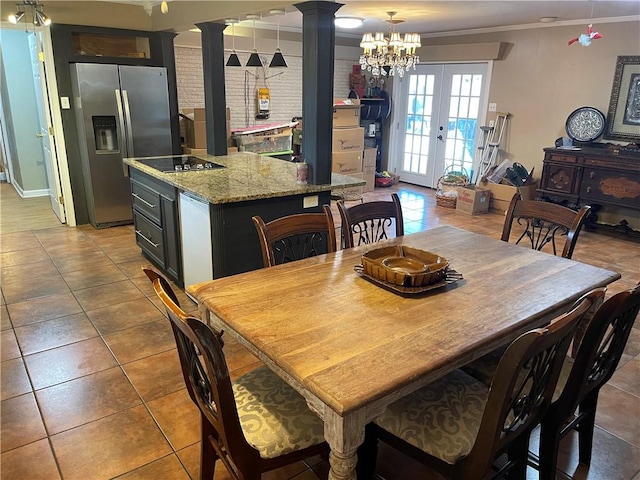 tiled dining area with french doors, ornate columns, and ornamental molding