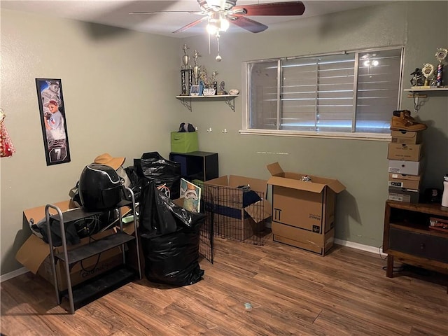 interior space with wood finished floors, baseboards, and ceiling fan