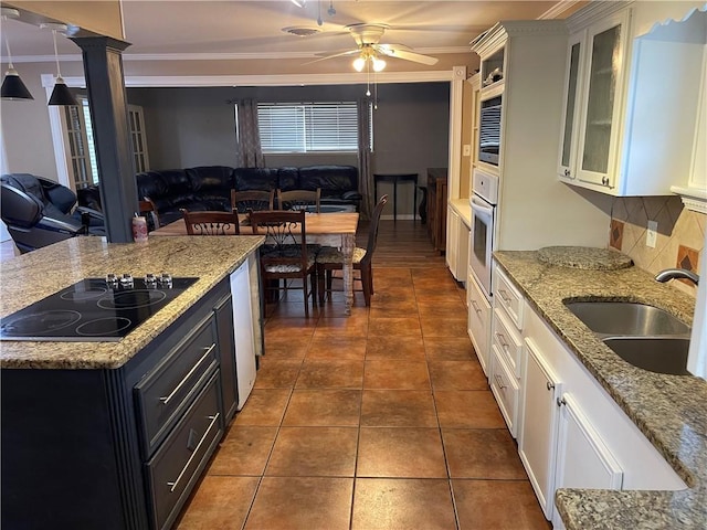 kitchen with a sink, black electric cooktop, open floor plan, and crown molding