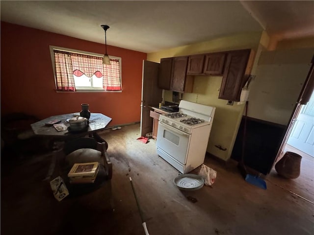 kitchen featuring hanging light fixtures and gas range gas stove