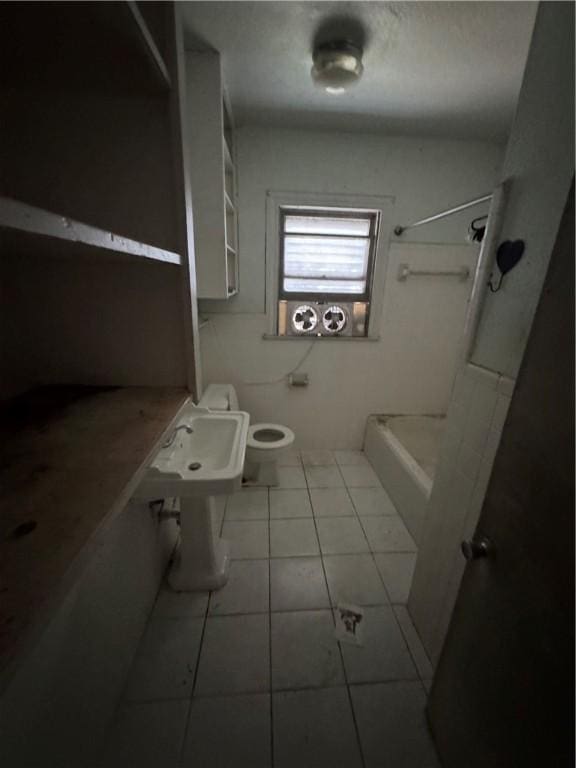 bathroom with tile patterned flooring, a shower, and toilet