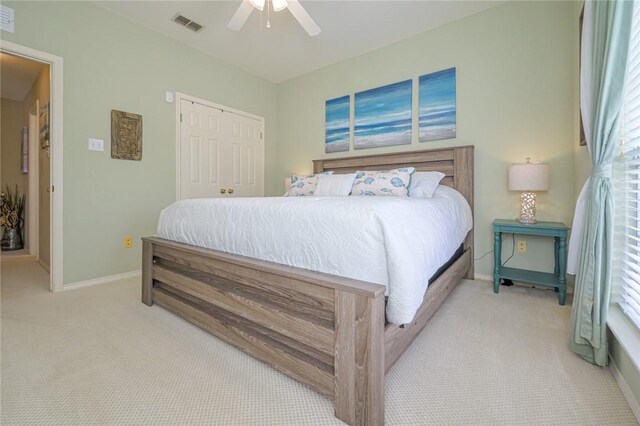 913 Pompano Dr, Aransas Pass, TX 78336 - bedroom with carpet, baseboards, a closet, and a ceiling fan