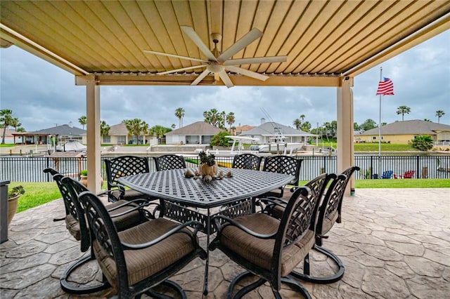 913 Pompano Dr, Aransas Pass, TX 78336 - view of patio / terrace with outdoor dining area, a ceiling fan, a residential view, and a water view