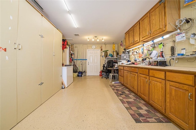 913 Pompano Dr, Aransas Pass, TX 78336 - kitchen with brown cabinetry, light countertops, and washer / dryer