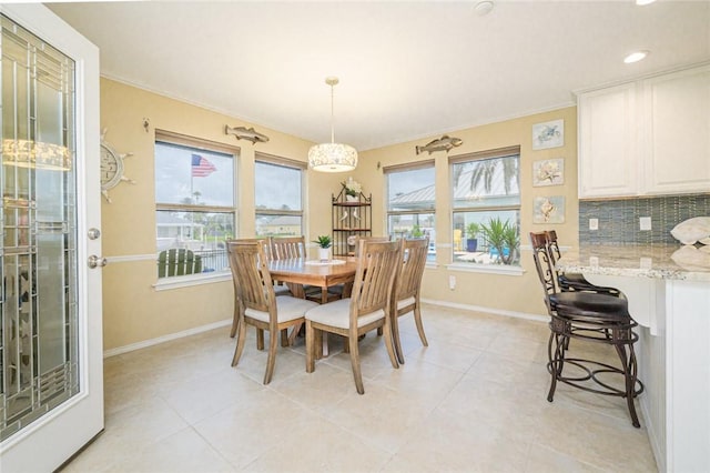 913 Pompano Dr, Aransas Pass, TX 78336 - dining area featuring baseboards, light tile patterned flooring, crown molding, and recessed lighting