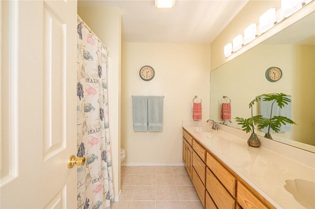 913 Pompano Dr, Aransas Pass, TX 78336 - full bathroom with double vanity, toilet, and tile patterned floors