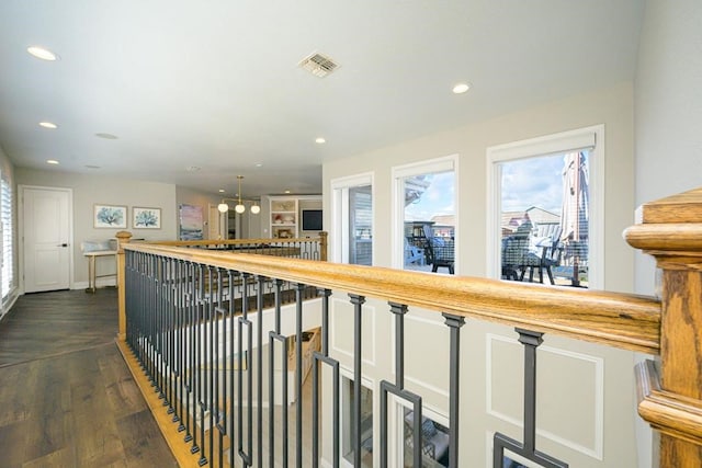 hallway with plenty of natural light, visible vents, and recessed lighting