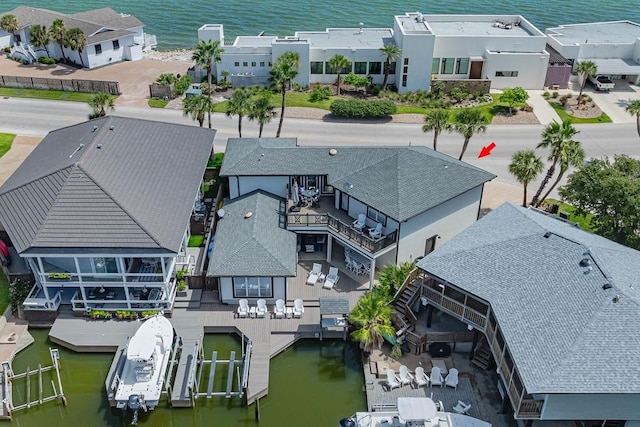 birds eye view of property with a water view and a residential view