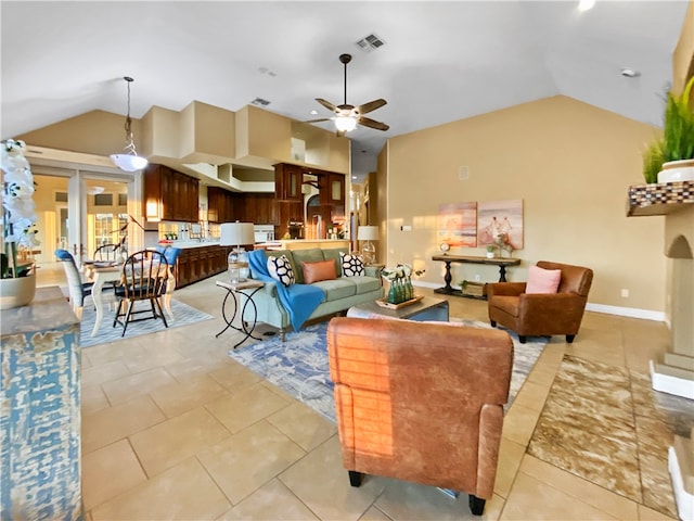 living room featuring light tile patterned flooring, ceiling fan, and vaulted ceiling