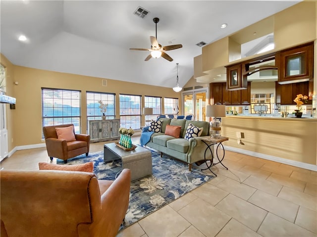 living room with high vaulted ceiling, ceiling fan, and light tile patterned floors