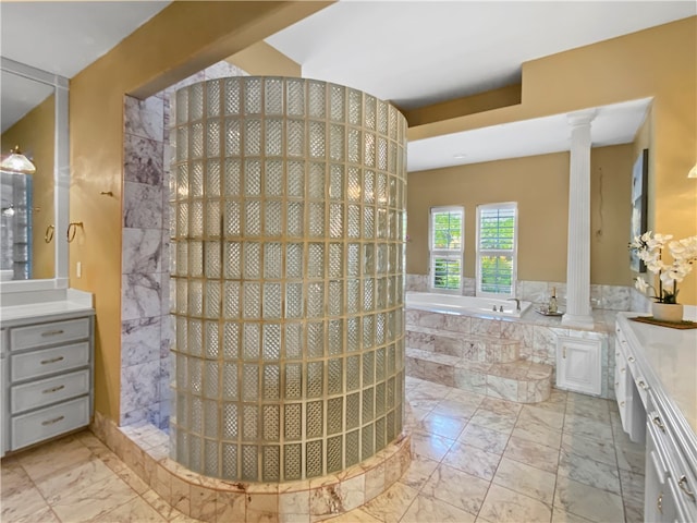 bathroom featuring plus walk in shower, vanity, and ornate columns