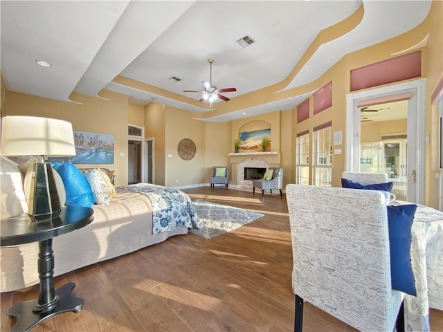 8029 Villefranche Dr, Corpus Christi, TX 78414 - bedroom featuring a fireplace, wood finished floors, baseboards, and a raised ceiling
