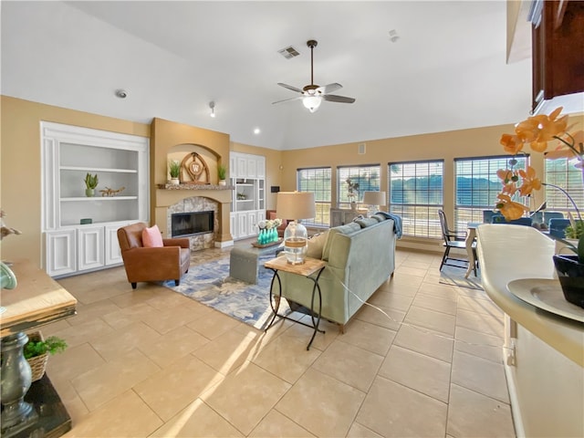 tiled living room featuring built in shelves, lofted ceiling, and ceiling fan