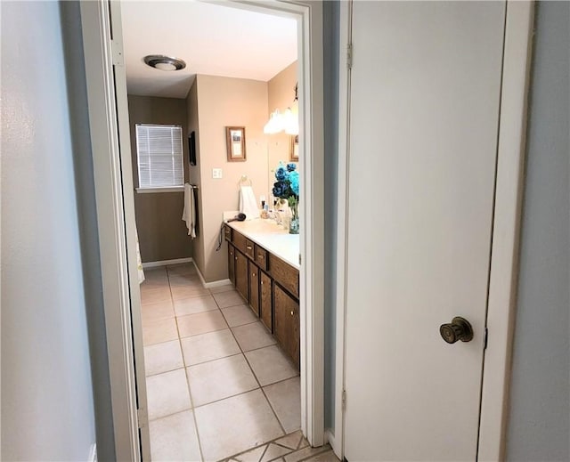 bathroom with tile patterned flooring, vanity, and baseboards