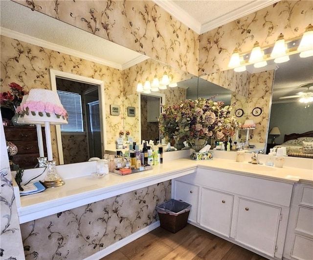 bathroom featuring wallpapered walls, a ceiling fan, ornamental molding, wood finished floors, and a shower stall