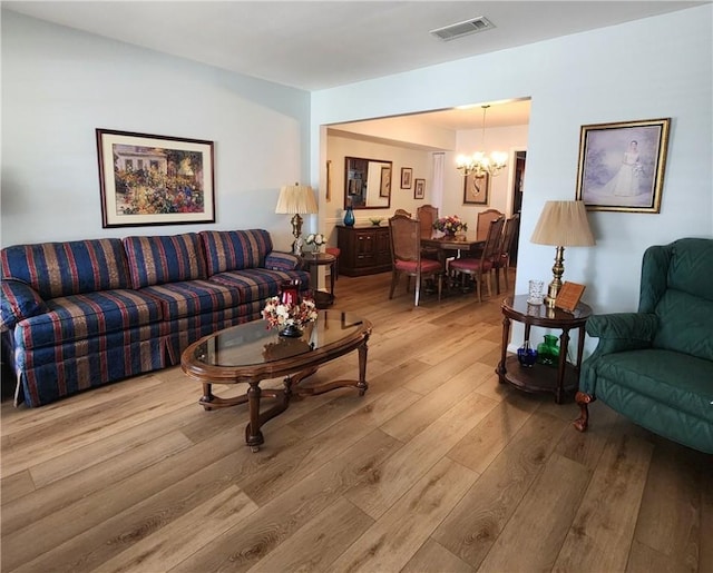 6421 Oakbrook Dr, Corpus Christi, TX 78413 - living room with visible vents, light wood-type flooring, and a notable chandelier