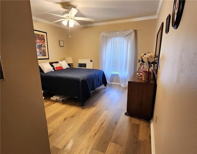 bedroom featuring light wood-type flooring, ceiling fan, and crown molding